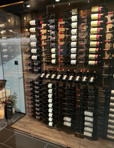 Complete WineGuard Pure wine room from Vinteknikk, with frameless glass walls, VinoWallRack metal shelves and integrated LED lighting for a modern, exclusive expression.